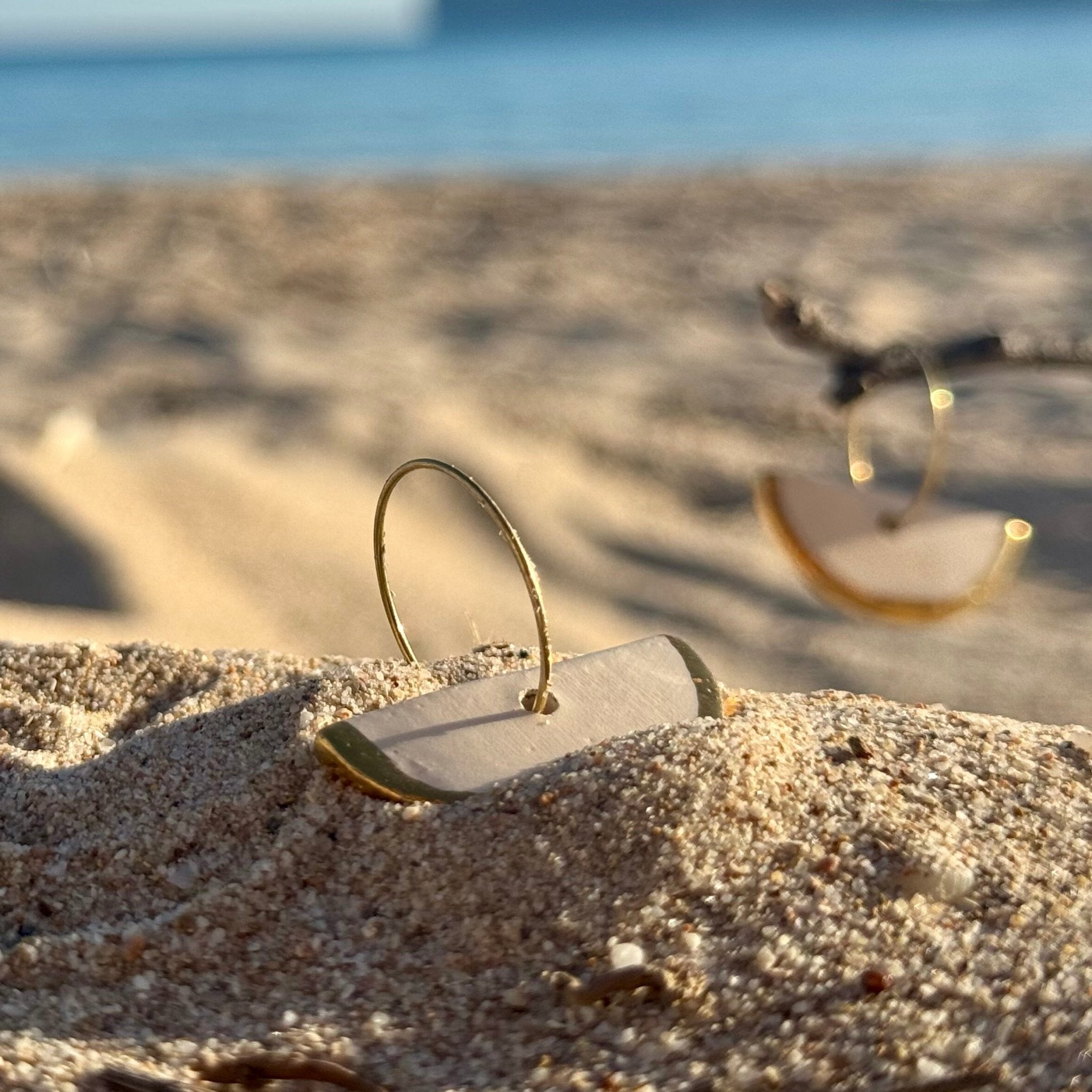 Doraluna | Handcrafted white ceramic dangle earrings with gold luster